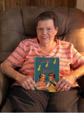 Older adult holding a book
