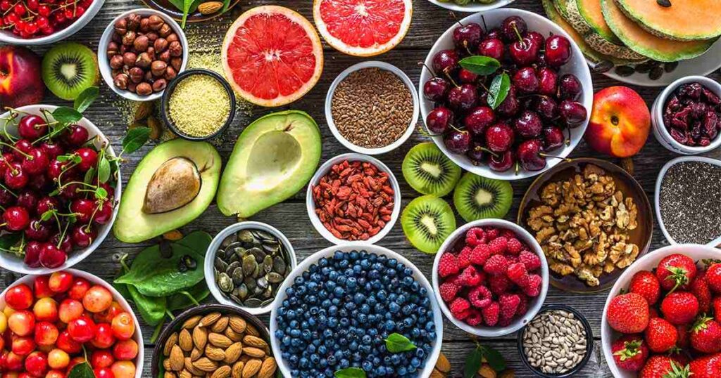Shows avocado, nuts, seeds and colorful fruits and vegetables, all foods that help aide wound healing